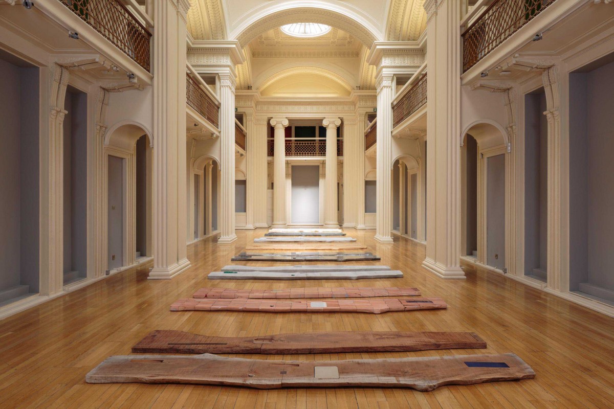  Lucy Skaer, 'Sticks and Stones (Part 1)', 2013-15. Mahogany with inserts of porcelain, limestone, tin, coins, American walnut, Tasmanian black wood. Installation view, Green Man, 2018. Image courtesy Talbot Rice Gallery, The University of Edinburgh.