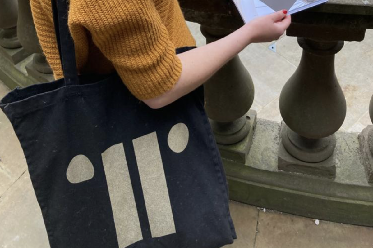 Close up image of black gold bag on person