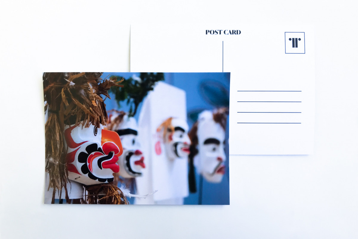 Image of Atlakim masks on postcard against white background