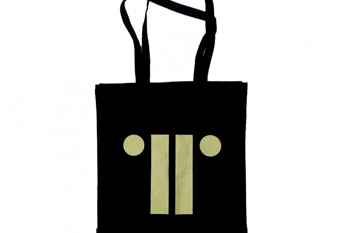 Black bag with TRG logo in gold against white background
