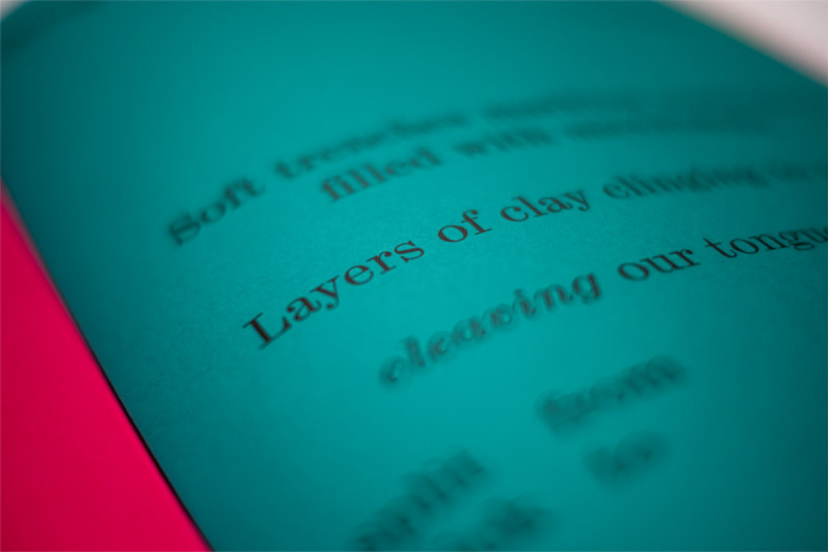 Detail of text focused on the words "layers of clay" printed onto turquoise paper