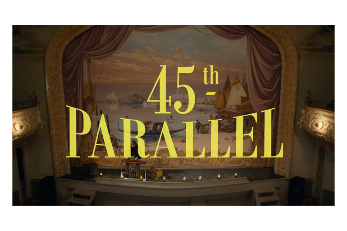 Video still of Venetian background theatre with yellow text "45th Parallel"