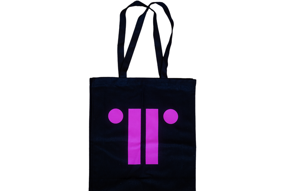 Black canvas bag with bright pink print of TRG logo against white background.