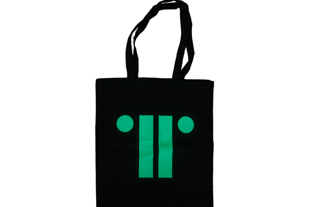 Black canvas bag with bright turquoise print of TRG logo against white background.