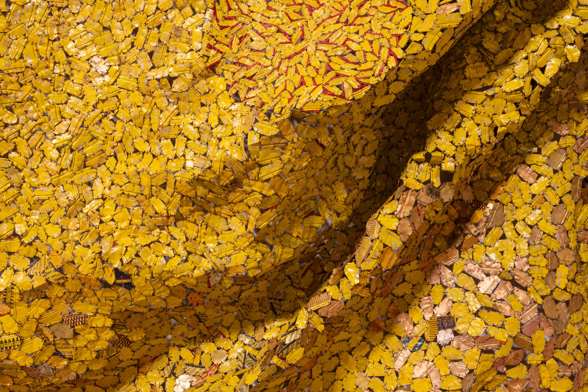 Yellow bottle cap tapestry with large folds across