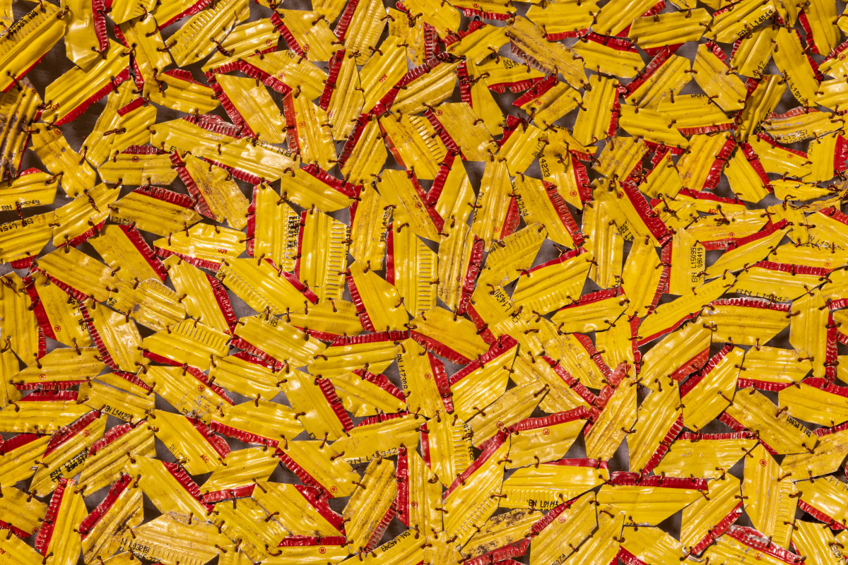 Yellow bottle cap tapestry with red highlights.