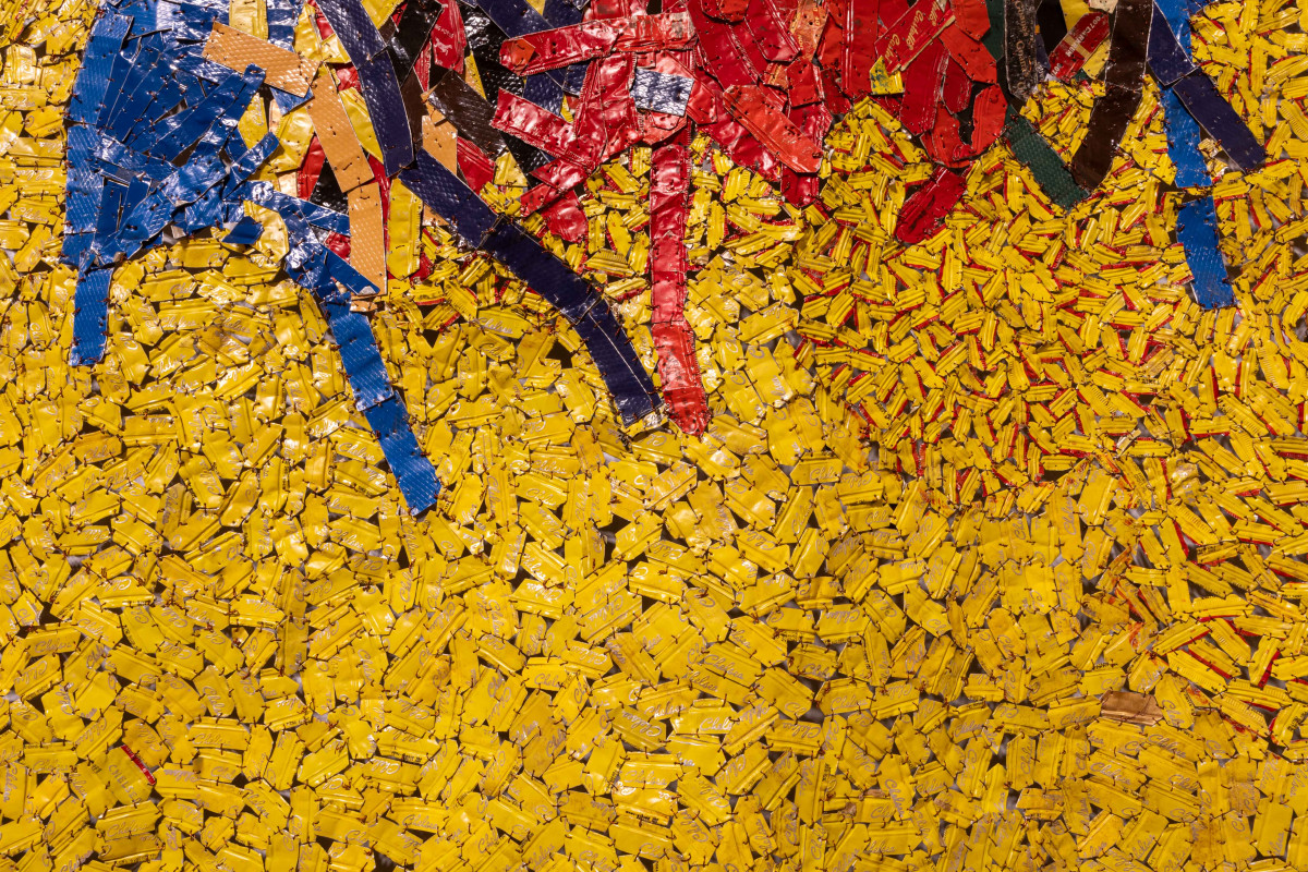 Yellow bottle cap tapestry with red, black and yellow lines at the top