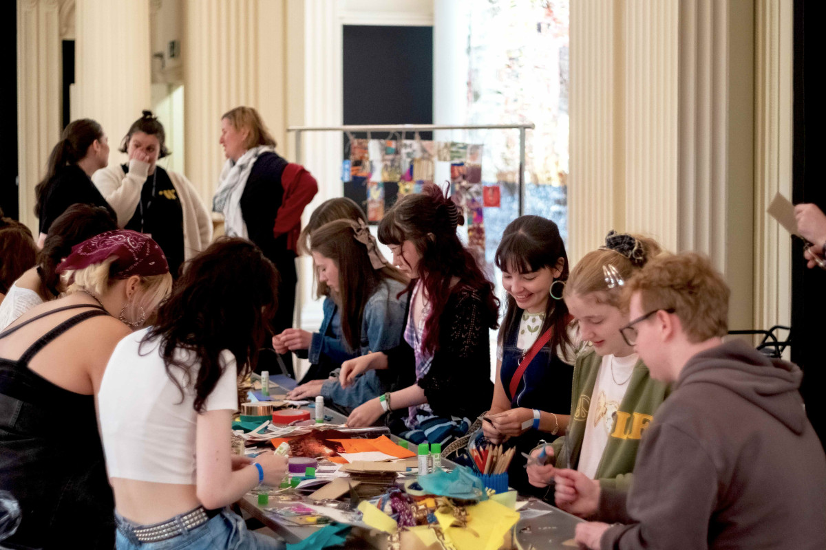 A group of people doing arts and crafts at a table