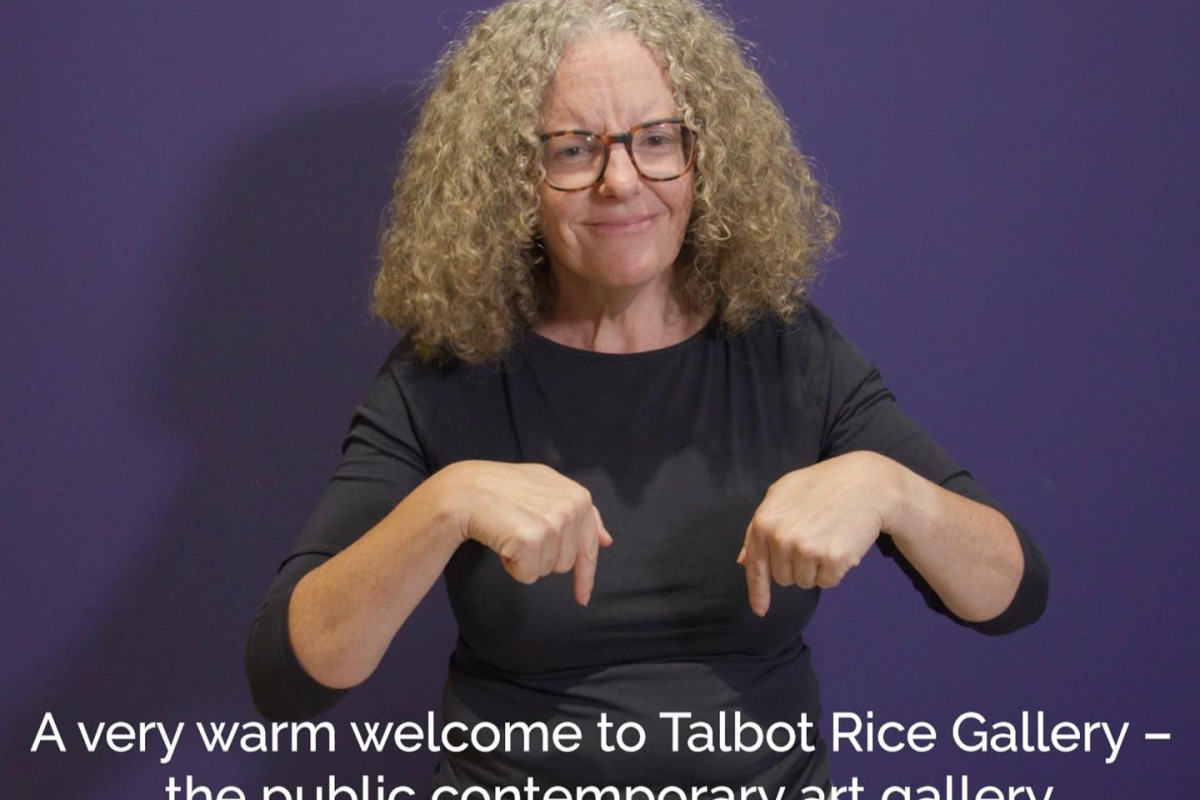 British Sign Language translator signs "Welcome to Talbot Rice Gallery"
