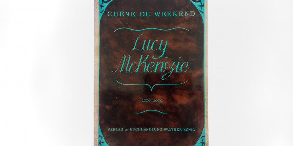 Front cover of Lucy McKenzie's book, shiny brown cover with teal text and decoration
